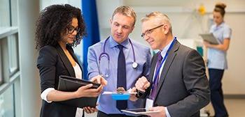 Healthcare manager consults with staff